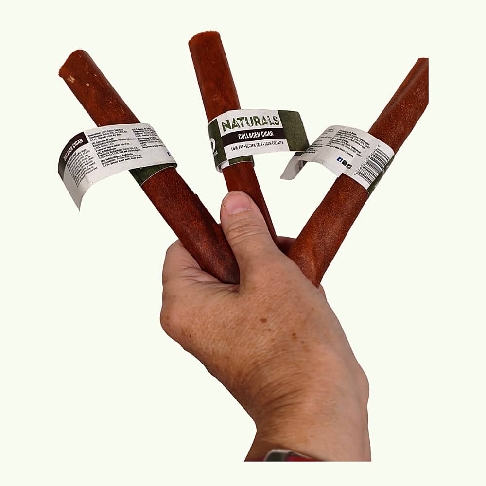 Hand holding three buffalo collagen cigars to show their size