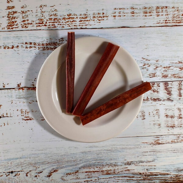 Three buffalo collagen sticks for dogs on a plate