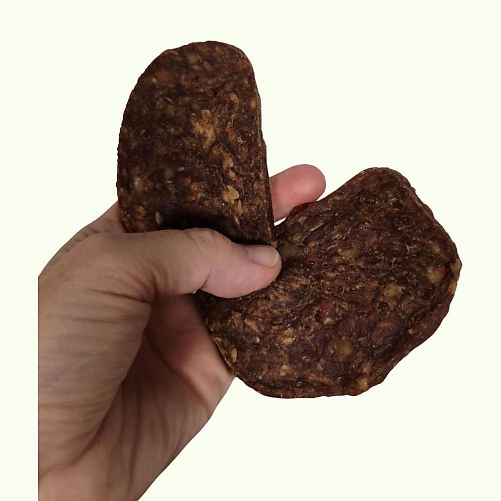 A duck and chicken grill held in a hand to show its size